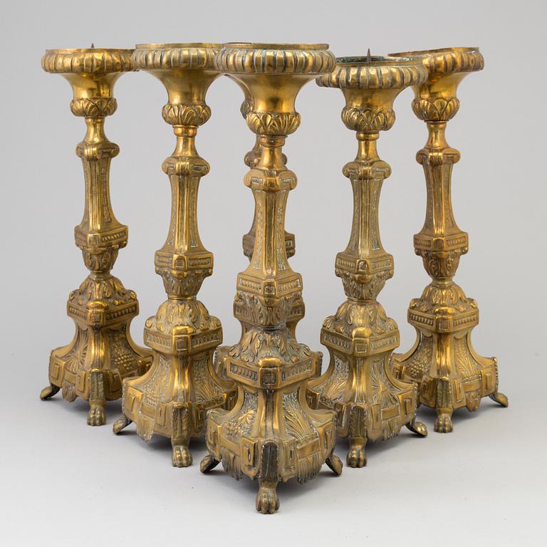 Six late 18th century brass candlesticks.