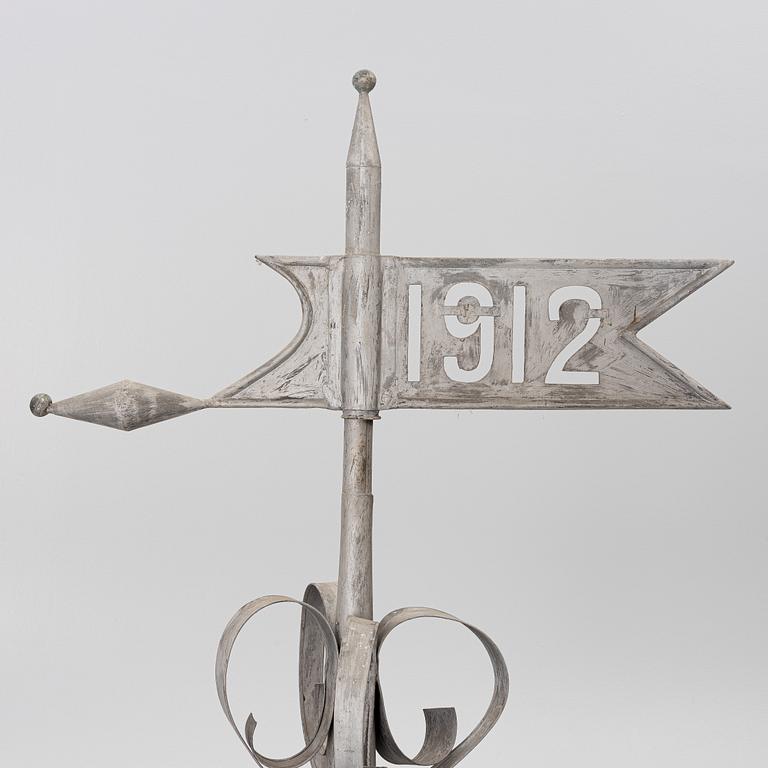 Tower spire with weather vane dated 1912.