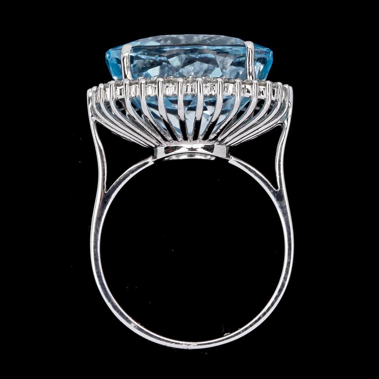 RING, rund fasettslipad blå topaz, ca 12 ct, med briljantslipade diamanter, tot. 0.50 ct.