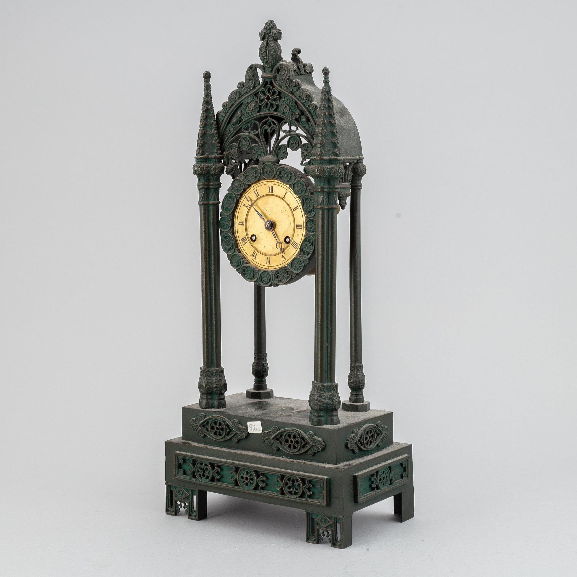A cast iron gothic revival mantel clock, late 19th century.