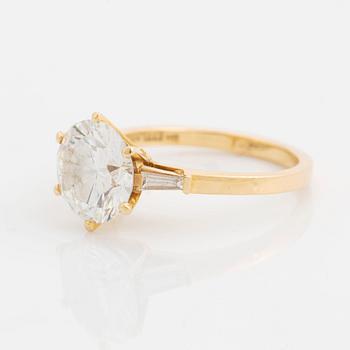 An 18K gold ring set with a round brilliant-cut diamond weight 3.30 cts quality E vs2.