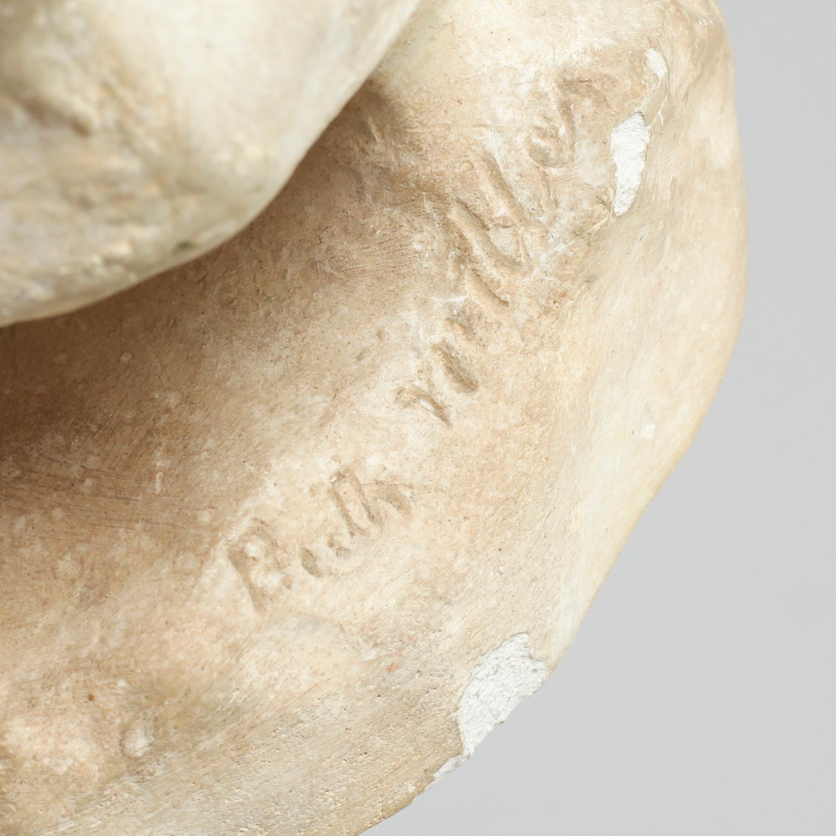 two plaster figurines, signed.