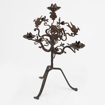 A wrought iron candelabra and a pair of wall sconces, Italy, mid/second half of the 20th century.