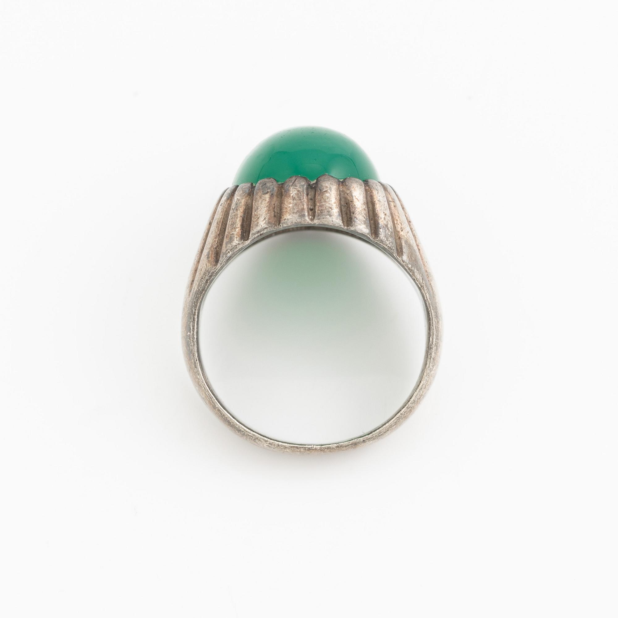Silver ring with a green cabochon-cut stone.