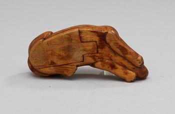 A 19th-20th century birch snuffbox in the shape of a lying dog.