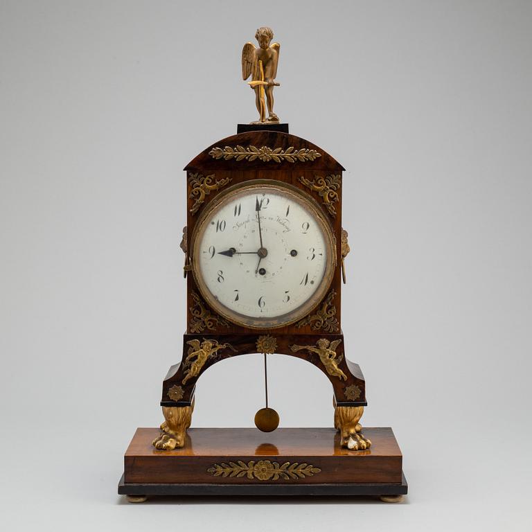 A Biedermeier pendulum clock, Vienna, first half of the 19th century.