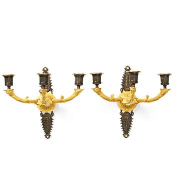 95. A pair of French Empire three-light wall-lights, early 19th century.