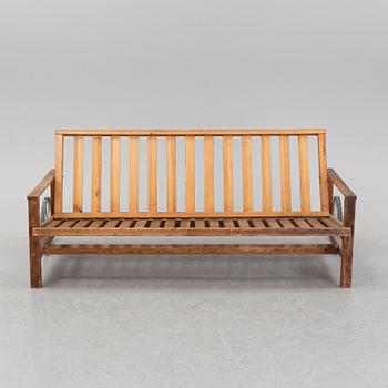 A stained pine garden sofa by Elsa Stackelberg.