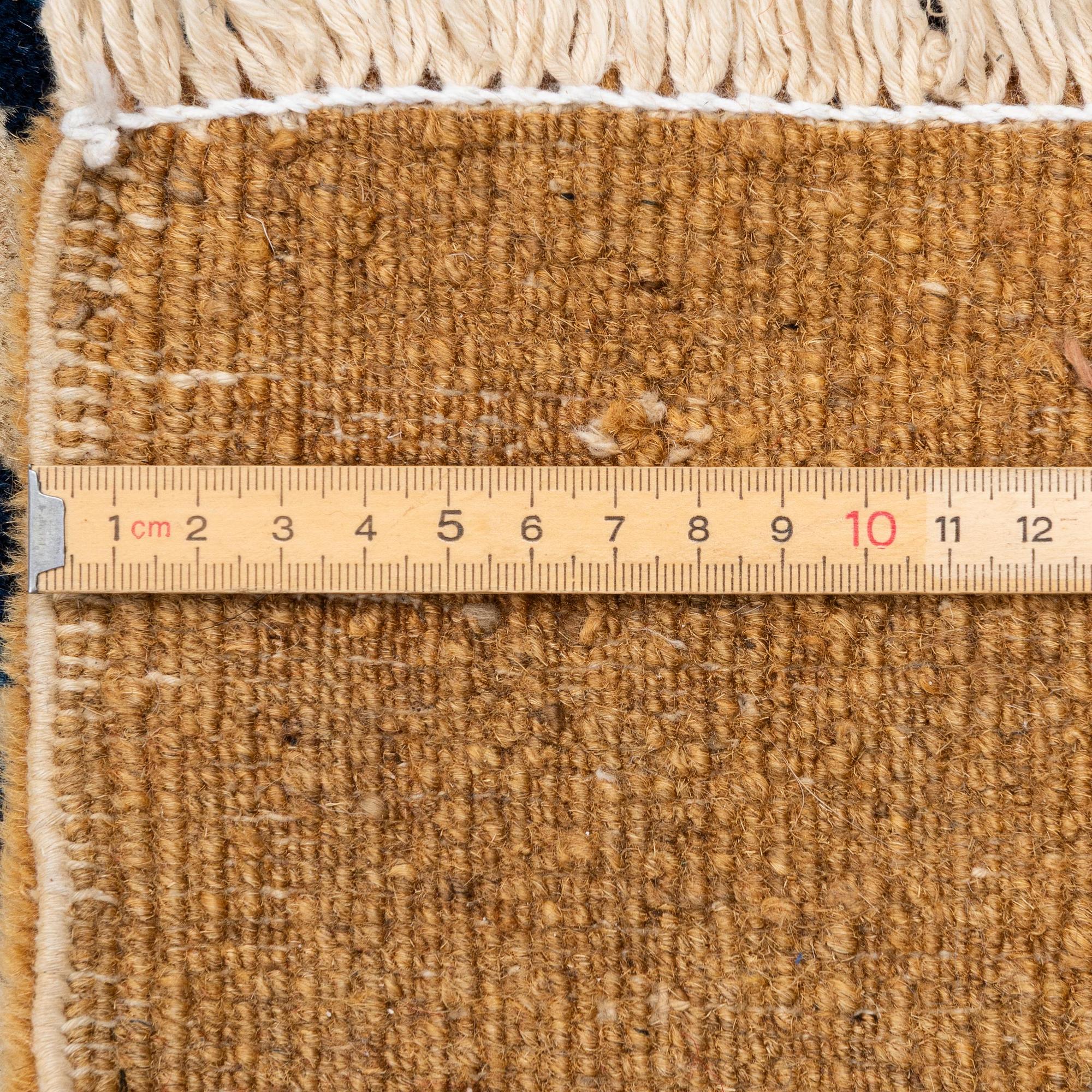 An antique Chinese carpet, 404 x 304 cm.