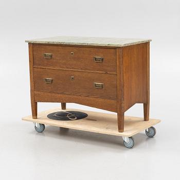 An oak and stone top chest of drawers, 1910's.