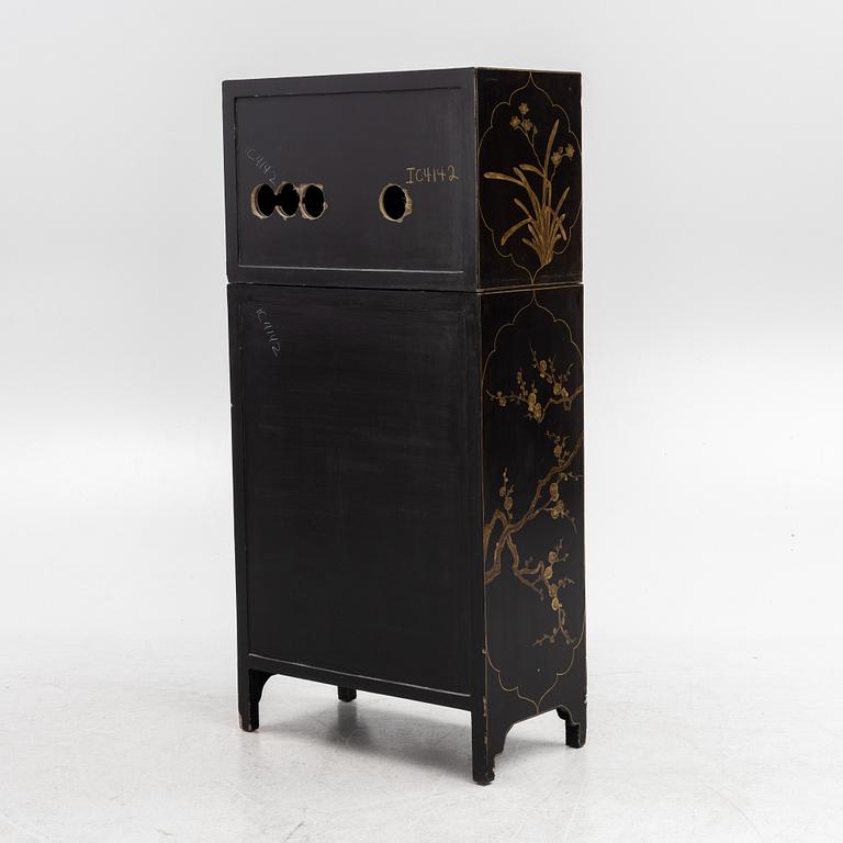 A Chinese lacquered two-part cabinet, first part of the 20th century.