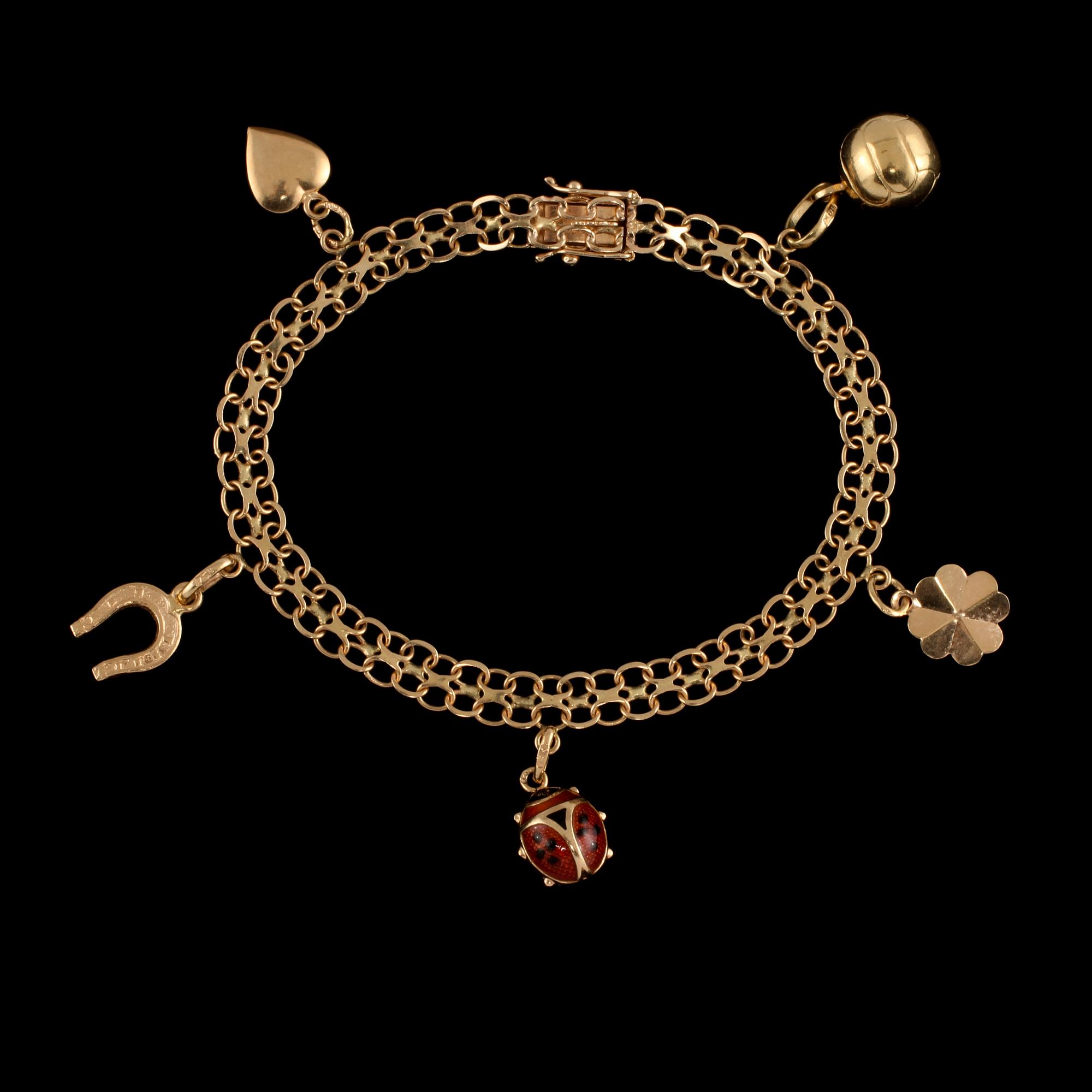 BERLOCKARMBAND, 18k guld samt emalj, Bäckman & Co, Stockholm, 1973. Vikt 9 g.