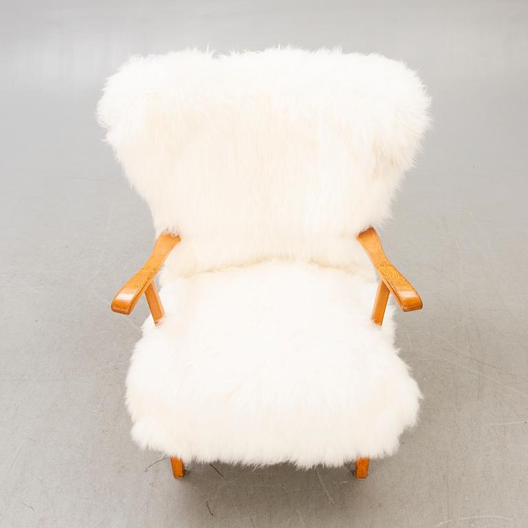 A 1940s sheepskin armchair.