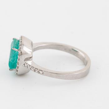 A emerald and brilliant cut diamond ring.