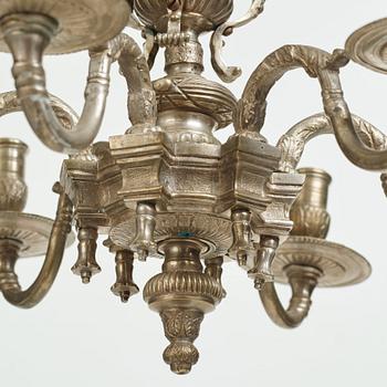 A Swedish silvered brass presumably late Baroque chandelier in the style of Jean Berain.