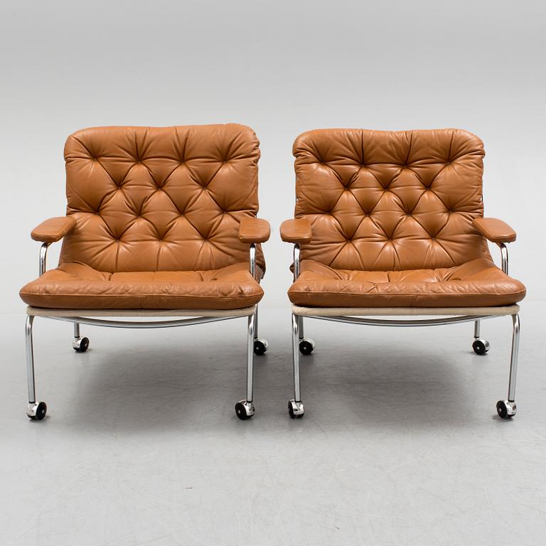 A pair of leather upholstered easy chairs, 1960's/70's.