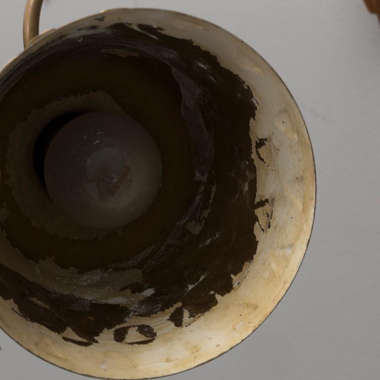 a 1950's brass and teak wall light.