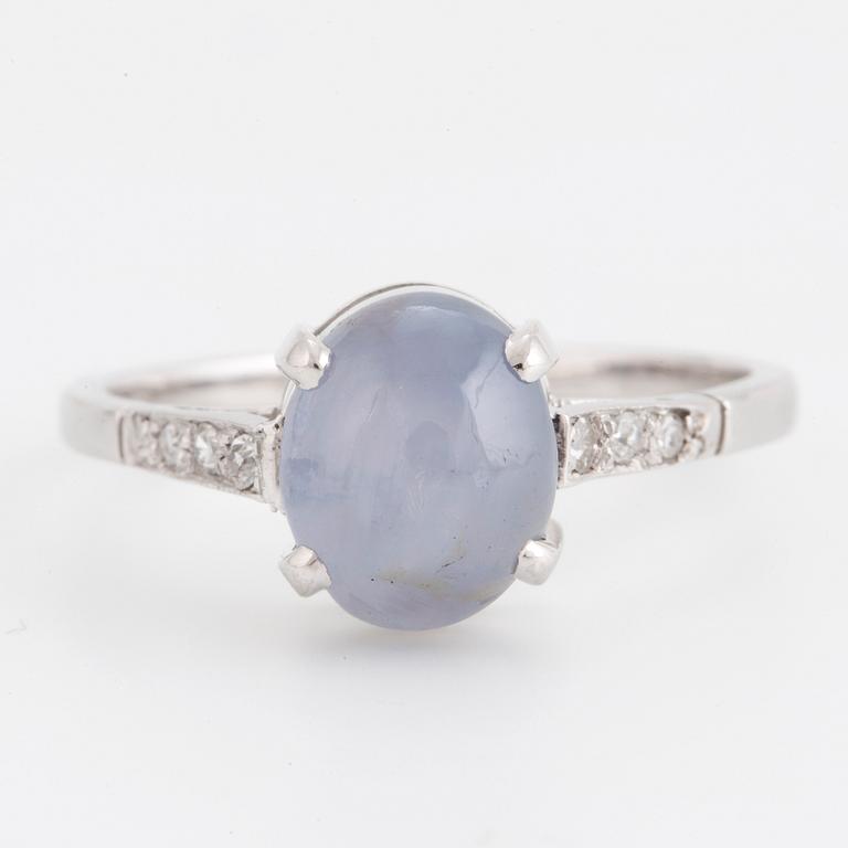 A cabochon-cut star sapphire and diamond ring.