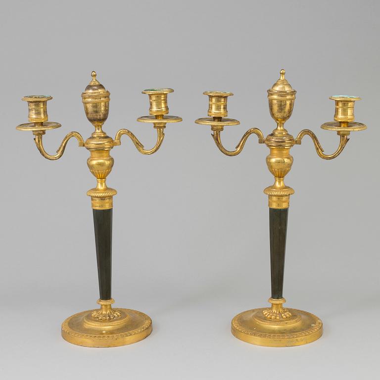 A pair of French Directoire late 18th century ormolu candelabra for three candles.