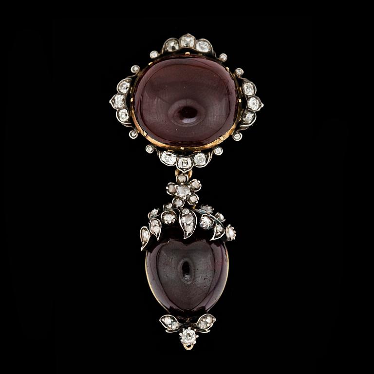 A garnet and diamond brooch, ca 1900.