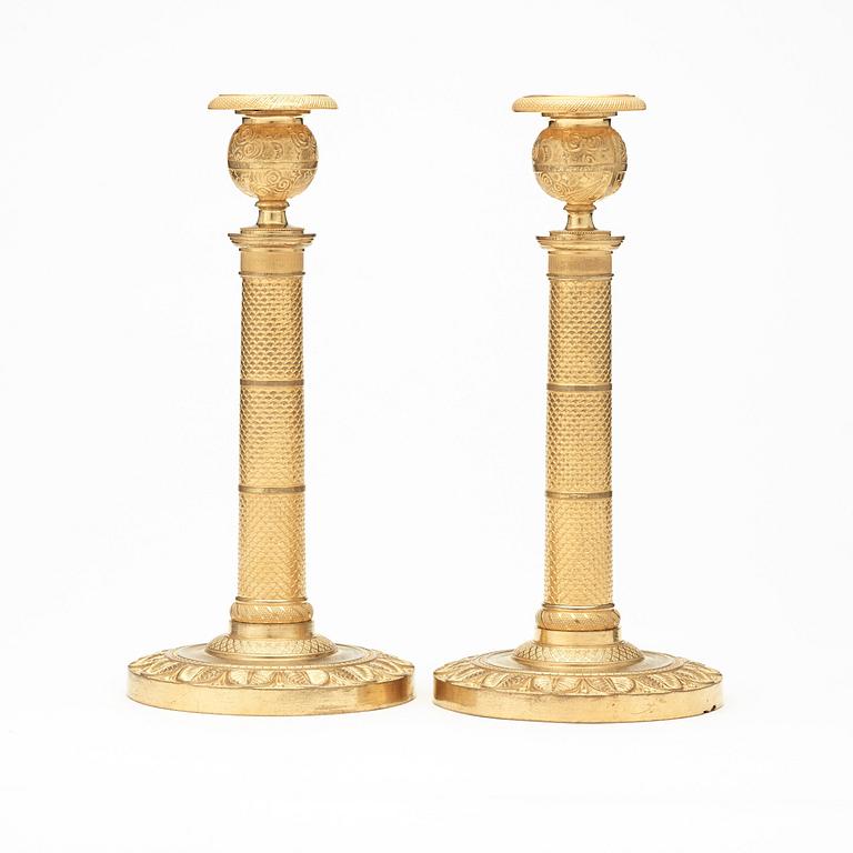 A pair of French Empire early 19th century candlesticks.