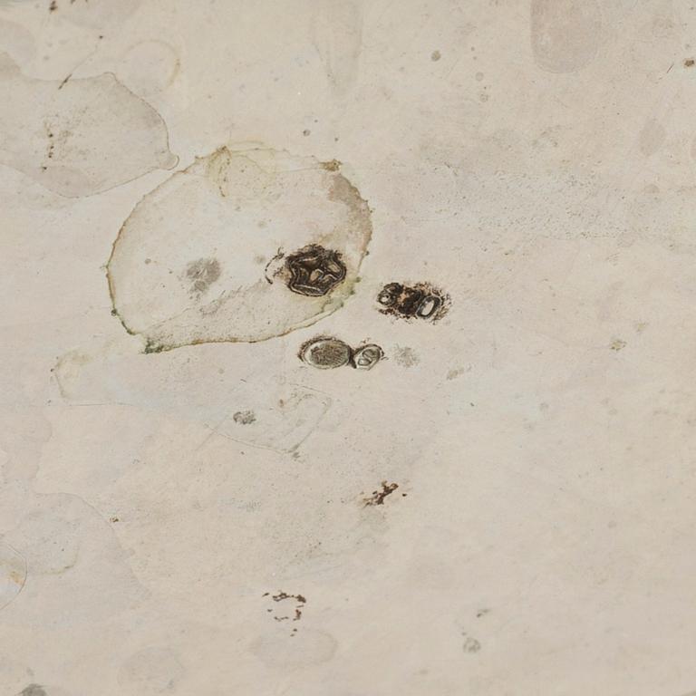 A silver rococo style teapot.