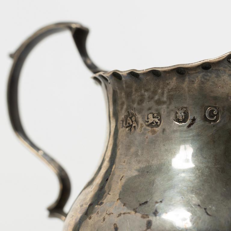 Two silver casters and cream jug, England.