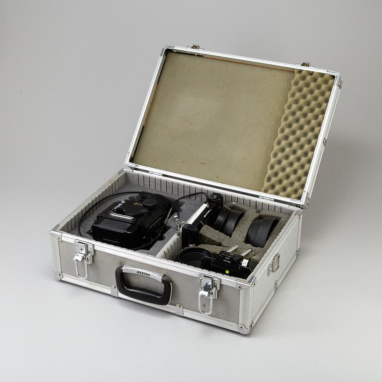 A black Mamiya RZ67 Pro Medium Format Camera Body with sekor z f = 110 mm 1:2.8 and sekor c f = 50 mm 1:4.5 lens.