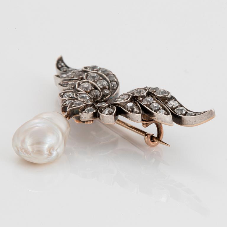 A silver and 14K gold brooch set with old-cut diamonds and a drop shaped pearl.