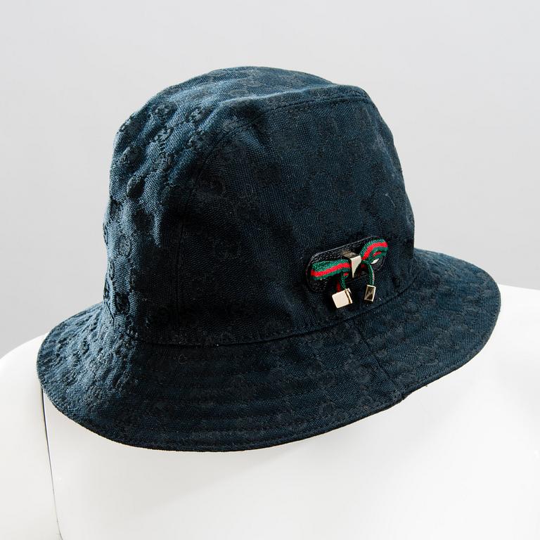 GUCCI, CAMEL HAIR PONCHO AND A HAT.