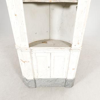 A painted Louis XVI style wallmounted corner cabinet.