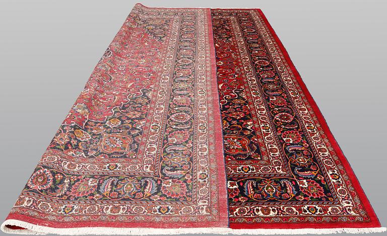 A signed Mashad carpet, ca 375 x 303 cm.