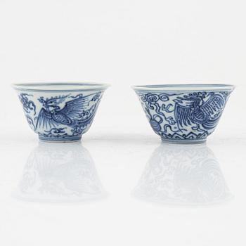 a pair of blue and white cups and three dishes, China, late Qing dynasty.