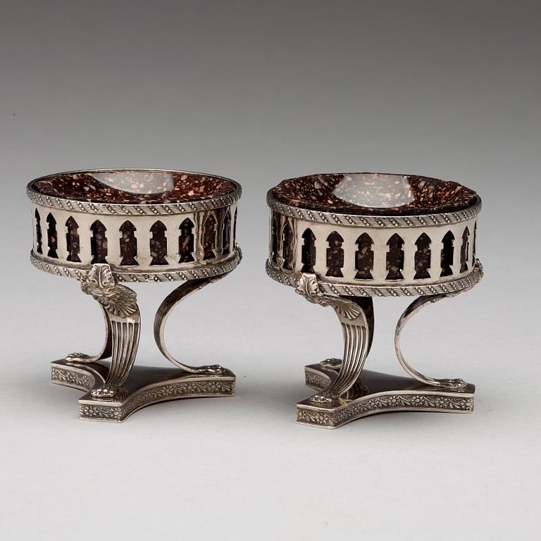 A pair of Swedish 19th century porphyry and silver salt-cellars, silver with mark of Gustaf Folcker, Stockholm 1823.