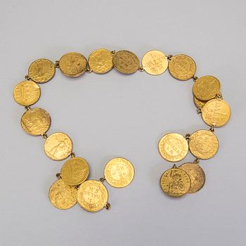 A collection of mostly silver, tradition folk buttons and belt buckles.