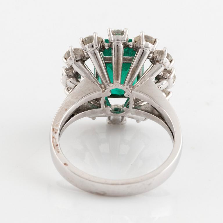 Ring med smaragd och runda briljantslipade diamanter.
