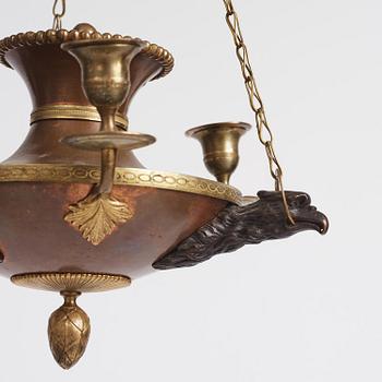 A Swedish patinated bronze and copper three-light chandelier, early 19th century.