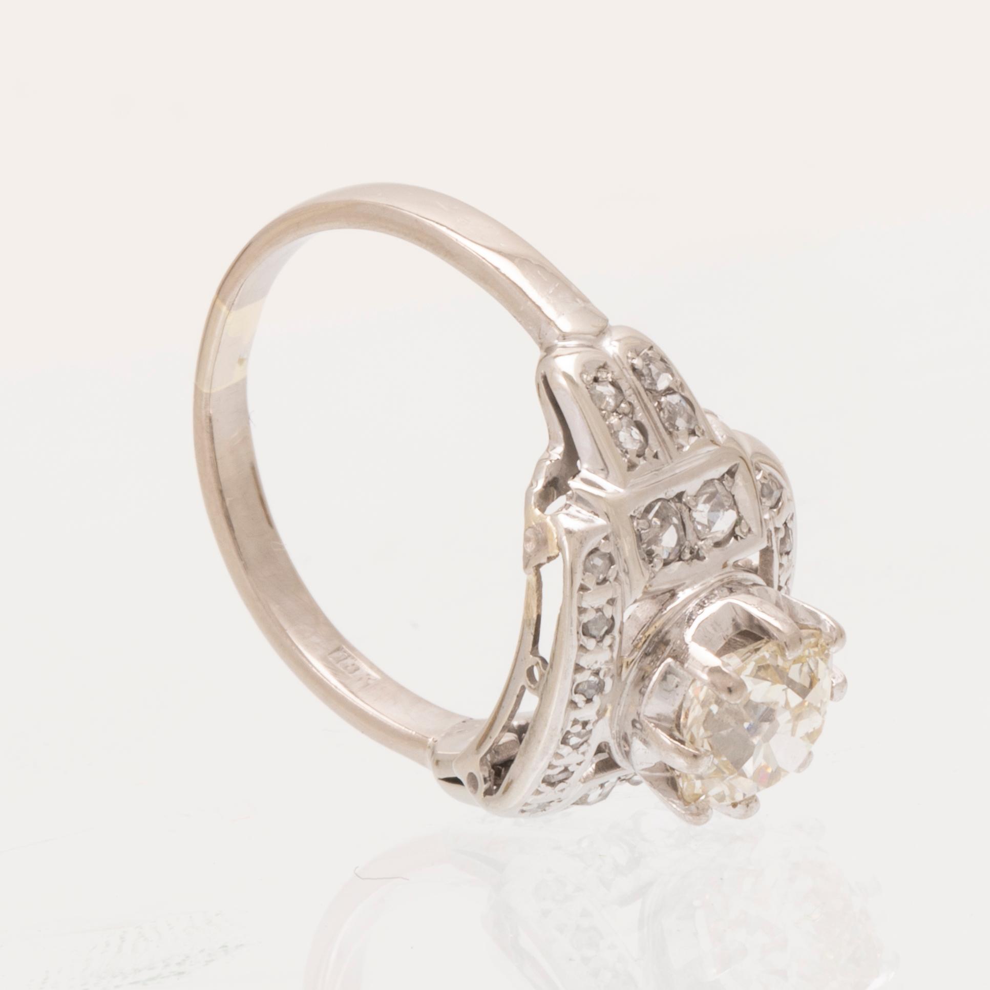 An 18K white gold ring set with an old cut diamond and rose cut diamonds.