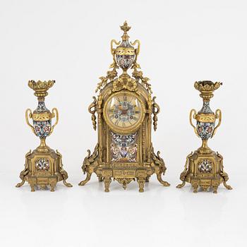 A set of two Louis XVI-style candle sticks and a mantle clock, late 19th century.