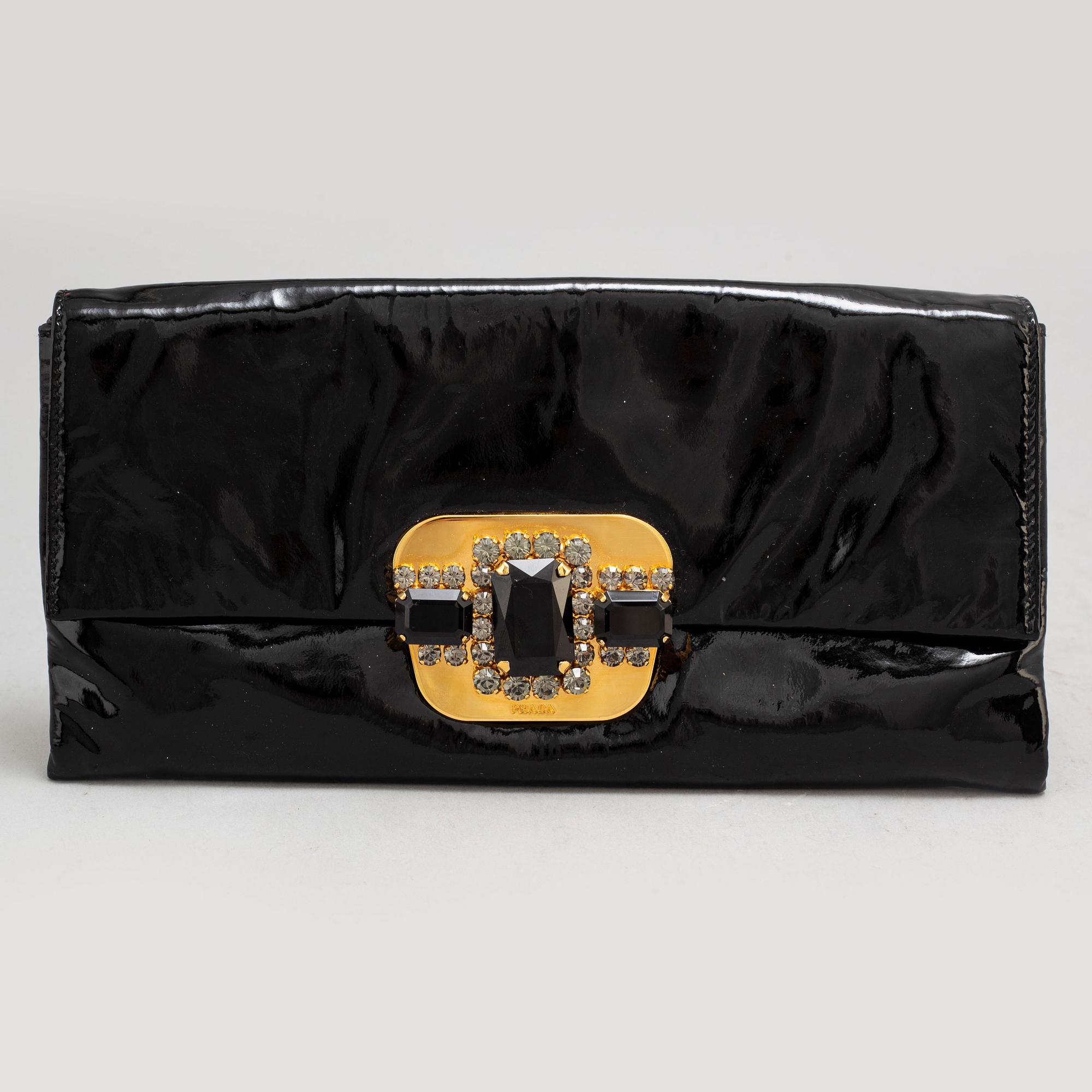 PRADA, a clutch.