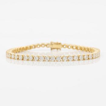 Tennis bracelet in 18K gold with round brilliant-cut diamonds.