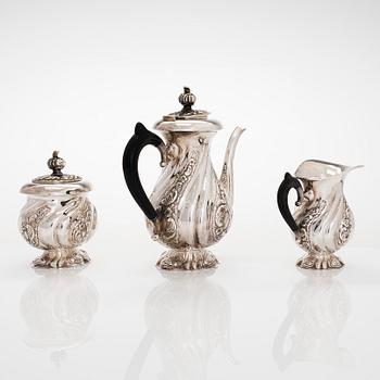 A three-piece silver coffee service, Swedish import marks. Silver sugar tongs, T.K. Alenius Vasa 1953.