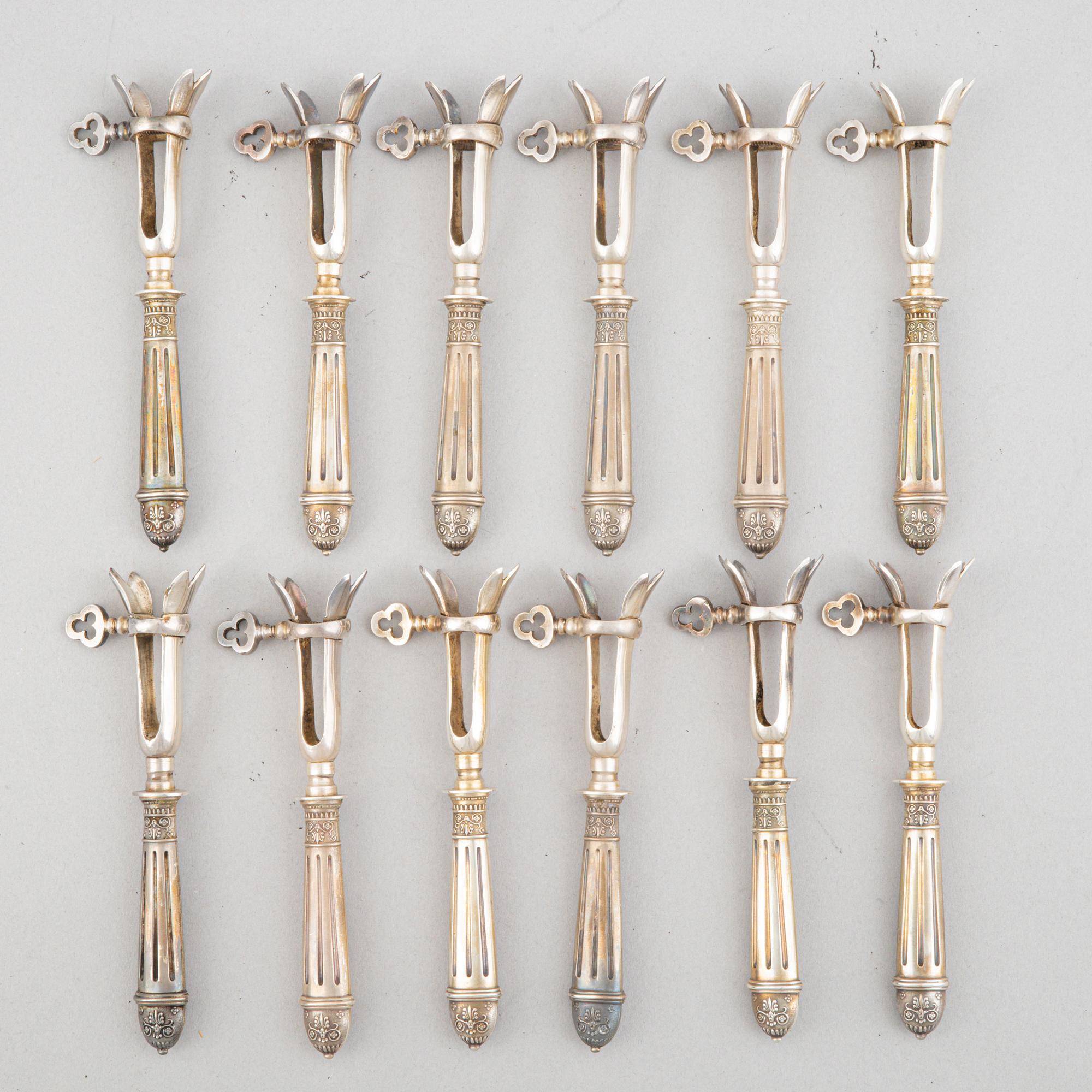 A set of six French silver pork chop holders, circa 1900.