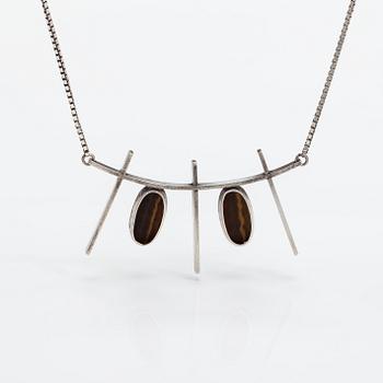 Kaulakoru, hopeaa ja tiikerinsilmää. Eero Eskelinen, Helsinki 1959.