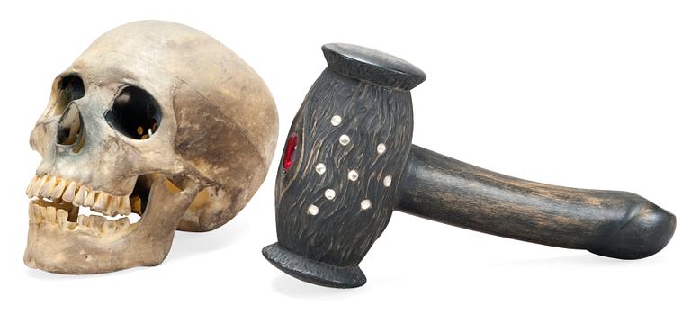 AN ARTIFICIAL SCULL AND A WOODEN HAMMER.