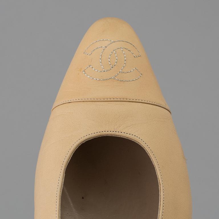 Beige leather slingbacks by Chanel.