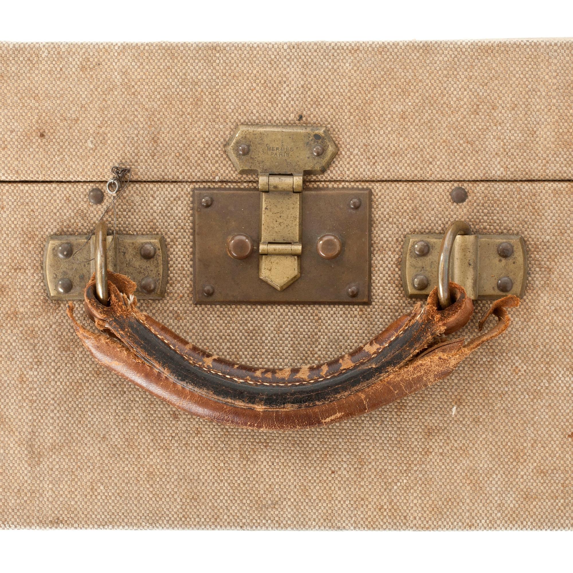 HERMÈS, a linen and leather suitcase, early 20th cent.