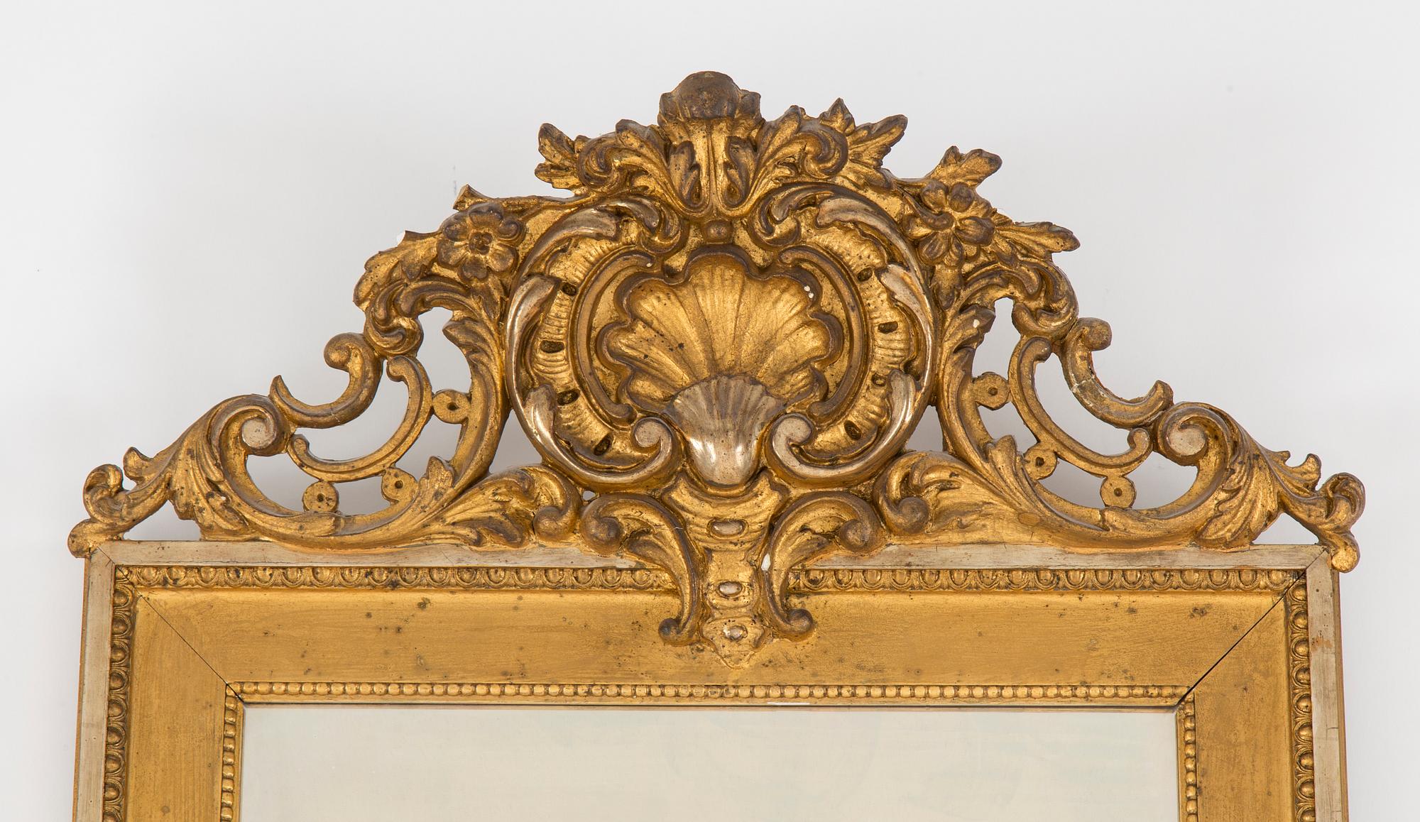 A Swedish Gustavian style mirror and console table with marble top from the first half of the 20th century.