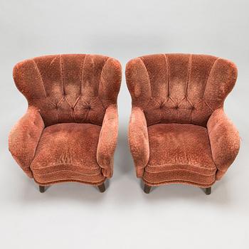 A pair of mid 20th Century armchairs.