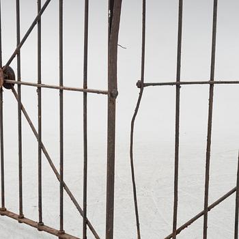 A pair of iron garden gates and a single gate from the early 20th century.